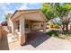Outdoor kitchen with a built-in grill under a covered patio with a ceiling fan at 5844 Gushing Spring Ave, Las Vegas, NV 89131