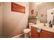 Well-decorated powder room with novelty wall decor and vanity with sink at 5844 Gushing Spring Ave, Las Vegas, NV 89131