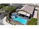 Aerial view of a home featuring a pool, putting green, covered patio, and lush landscaping, offering a private backyard oasis at 5852 Ireland Ridge Ct, Las Vegas, NV 89149