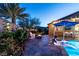 Lush backyard with a pool, fire pit, hammock, and desert landscaping, perfect for relaxed outdoor living at 5852 Ireland Ridge Ct, Las Vegas, NV 89149