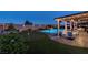 Backyard featuring a putting green, pool with fire feature, and covered patio at 5852 Ireland Ridge Ct, Las Vegas, NV 89149