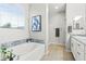 Bright bathroom featuring a tub with granite surround, and large window providing natural light at 5852 Ireland Ridge Ct, Las Vegas, NV 89149
