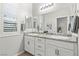 Bathroom showcasing a double vanity with granite countertop and decorative mirrors at 5852 Ireland Ridge Ct, Las Vegas, NV 89149