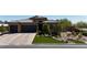 Beautiful single-story home with a tile roof, dark garage doors, and manicured front yard landscaping at 5852 Ireland Ridge Ct, Las Vegas, NV 89149