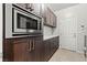 Modern kitchen featuring stainless steel microwave, sleek countertops, and contemporary cabinetry at 5852 Ireland Ridge Ct, Las Vegas, NV 89149