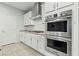 Close-up of modern stainless-steel appliances, including double ovens, and white cabinetry at 5852 Ireland Ridge Ct, Las Vegas, NV 89149