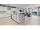 Open-concept kitchen with island, stainless appliances, seamlessly connecting to living and outdoor spaces at 5852 Ireland Ridge Ct, Las Vegas, NV 89149
