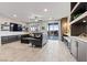 Bright living room featuring tile floors, sliding glass door to pool, modern shelving and comfortable seating at 5852 Ireland Ridge Ct, Las Vegas, NV 89149
