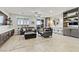 Spacious living room with tile floors, wet bar and comfortable leather seating, perfect for entertaining at 5852 Ireland Ridge Ct, Las Vegas, NV 89149