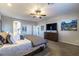Spacious carpeted main bedroom featuring neutral paint, ceiling fan, view to main bathroom at 5852 Ireland Ridge Ct, Las Vegas, NV 89149