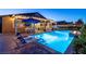 Inviting backyard pool and patio with in-pool seating and lush landscaping at 5852 Ireland Ridge Ct, Las Vegas, NV 89149
