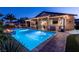 Stunning backyard pool with a covered patio and a fire pit, perfect for outdoor entertaining at 5852 Ireland Ridge Ct, Las Vegas, NV 89149