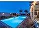 Inviting pool area featuring a shimmering pool, fire feature, and lush greenery, creating a tranquil oasis at 5852 Ireland Ridge Ct, Las Vegas, NV 89149