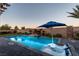 Inviting backyard pool with lounge chairs, fire feature, and putting green at 5852 Ireland Ridge Ct, Las Vegas, NV 89149
