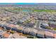 This aerial view focuses on the home's location in the neighborhood with a nearby lake and park at 600 Suncrest Peak Pl, Henderson, NV 89011
