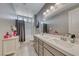 This bathroom features a shower/tub combo, double sinks with quartz countertop, and large mirror at 600 Suncrest Peak Pl, Henderson, NV 89011