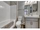 Well-lit bathroom featuring a shower-tub combo and a modern vanity with ample storage at 600 Suncrest Peak Pl, Henderson, NV 89011