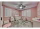 This Bedroom features pink walls, white window shutters, carpet, and a ceiling fan with light at 600 Suncrest Peak Pl, Henderson, NV 89011