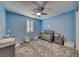 This Bedroom features blue walls, white window shutters, carpet, and a ceiling fan with light at 600 Suncrest Peak Pl, Henderson, NV 89011