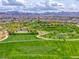 Aerial view of a neighborhood park featuring a pool and open grass areas at 600 Suncrest Peak Pl, Henderson, NV 89011
