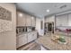 Kitchen features granite countertops, grey cabinets and stainless refrigerator at 600 Suncrest Peak Pl, Henderson, NV 89011