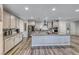 Modern kitchen with gray cabinets, granite counters, stainless appliances and island at 600 Suncrest Peak Pl, Henderson, NV 89011