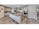 Contemporary kitchen featuring a large island, granite countertops, and gray cabinets at 600 Suncrest Peak Pl, Henderson, NV 89011
