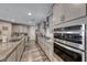 Kitchen with stainless steel appliances, gray cabinets, and granite countertops at 600 Suncrest Peak Pl, Henderson, NV 89011