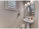 This powder room features a pedestal sink, a large mirror, and a window with white shutters at 600 Suncrest Peak Pl, Henderson, NV 89011