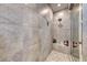 The walk-in shower features gray tile, a rainfall shower head, and built-in bench with niche for toiletries at 600 Suncrest Peak Pl, Henderson, NV 89011