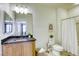 Neutral bathroom with a granite countertop and a shower behind a white curtain at 6255 W Arby Ave # 118, Las Vegas, NV 89118