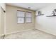Bedroom with neutral carpet, two windows with blinds, and two floating shelves on the wall at 6255 W Arby Ave # 118, Las Vegas, NV 89118