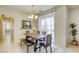Bright dining area features a wooden table and chairs, complemented by a sliding glass door at 6255 W Arby Ave # 118, Las Vegas, NV 89118