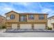 Inviting townhouse with tan exterior and multiple garage spaces, set against a clear blue sky at 6255 W Arby Ave # 118, Las Vegas, NV 89118