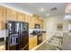 Well-equipped kitchen features modern appliances and wood cabinetry, creating a functional cooking space at 6255 W Arby Ave # 118, Las Vegas, NV 89118