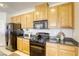 View of the kitchen with stainless steel appliances and wooden cabinetry at 6255 W Arby Ave # 118, Las Vegas, NV 89118