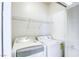 Well-lit laundry room with a washer, dryer, and shelving at 6255 W Arby Ave # 118, Las Vegas, NV 89118