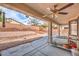 View of covered back porch with ceiling fan, and view of rock groundcover and backyard brick fence at 6329 Sterling Ranch Way, North Las Vegas, NV 89081