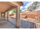 View of back porch with white fencing, brick retaining wall with rock ground cover at 6329 Sterling Ranch Way, North Las Vegas, NV 89081