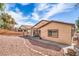 Spacious backyard features tasteful gravel landscaping and covered patio on a sunny day at 6329 Sterling Ranch Way, North Las Vegas, NV 89081