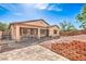 The backyard features a charming patio area and terraced landscaping with stone and gravel accents at 6329 Sterling Ranch Way, North Las Vegas, NV 89081