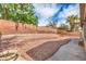 A spacious backyard features tiered landscaping with stone accents, offering privacy and a natural aesthetic at 6329 Sterling Ranch Way, North Las Vegas, NV 89081