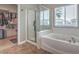 Bathroom including a glass shower, soaking tub, and walk-in closet at 6329 Sterling Ranch Way, North Las Vegas, NV 89081