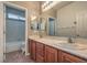 Bright bathroom featuring double sink vanity, and combination shower and tub at 6329 Sterling Ranch Way, North Las Vegas, NV 89081