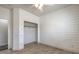 Bright bedroom with modern accent wall and light floors lead to a walk-in closet at 6329 Sterling Ranch Way, North Las Vegas, NV 89081