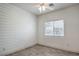 Minimalist bedroom featuring wide plank floors and accent wall with natural light from a large window at 6329 Sterling Ranch Way, North Las Vegas, NV 89081