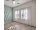 Bright bedroom featuring modern accent wall, light floors, and large windows with shutter blinds at 6329 Sterling Ranch Way, North Las Vegas, NV 89081