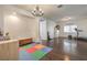 Spacious bonus room with hardwood flooring, great natural light, and a chandelier at 6329 Sterling Ranch Way, North Las Vegas, NV 89081