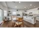 Bright kitchen featuring stainless steel appliances, white cabinets, marble countertops, and a dining area with hardwood floors at 6329 Sterling Ranch Way, North Las Vegas, NV 89081