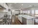 Spacious and bright kitchen featuring stainless steel appliances, marble countertops, and hardwood floors at 6329 Sterling Ranch Way, North Las Vegas, NV 89081